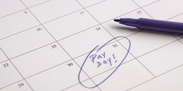 the words 'pay day' circled in purple felt pen on a calendar