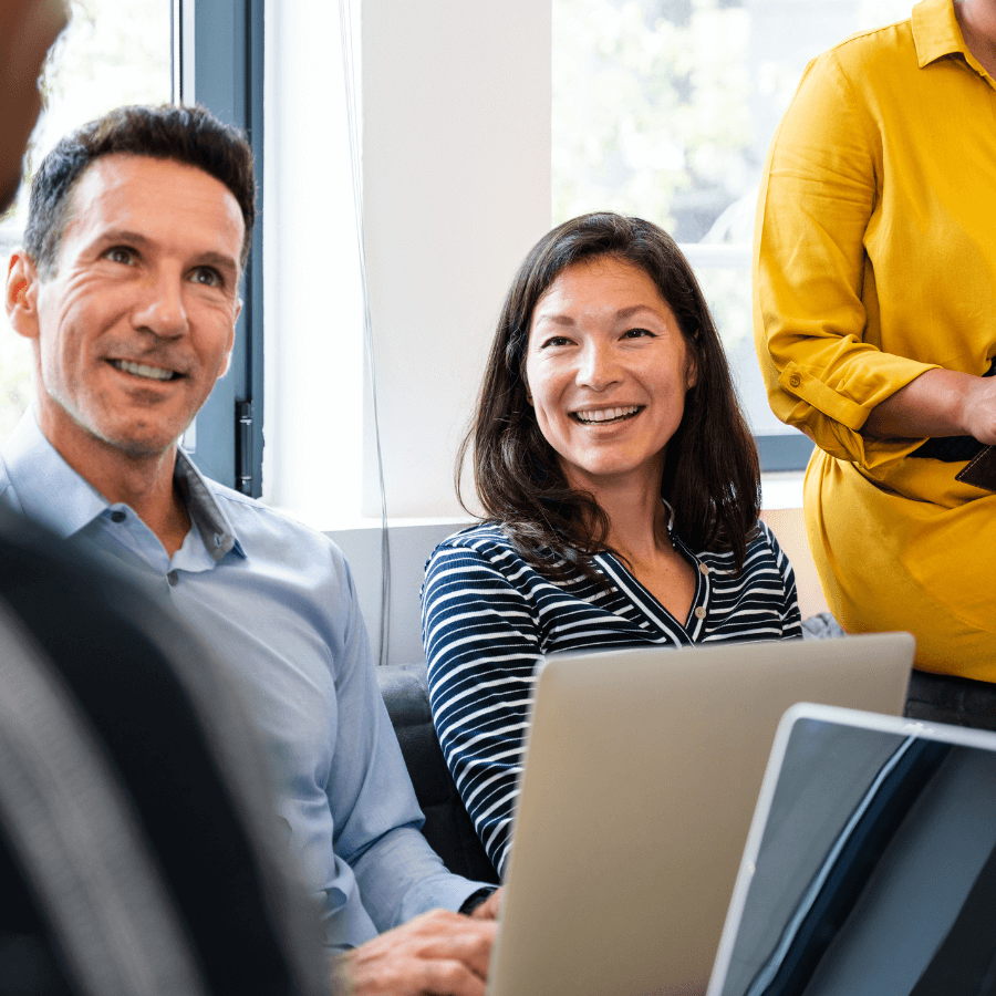 caucasian male and asian female colleague in discussion