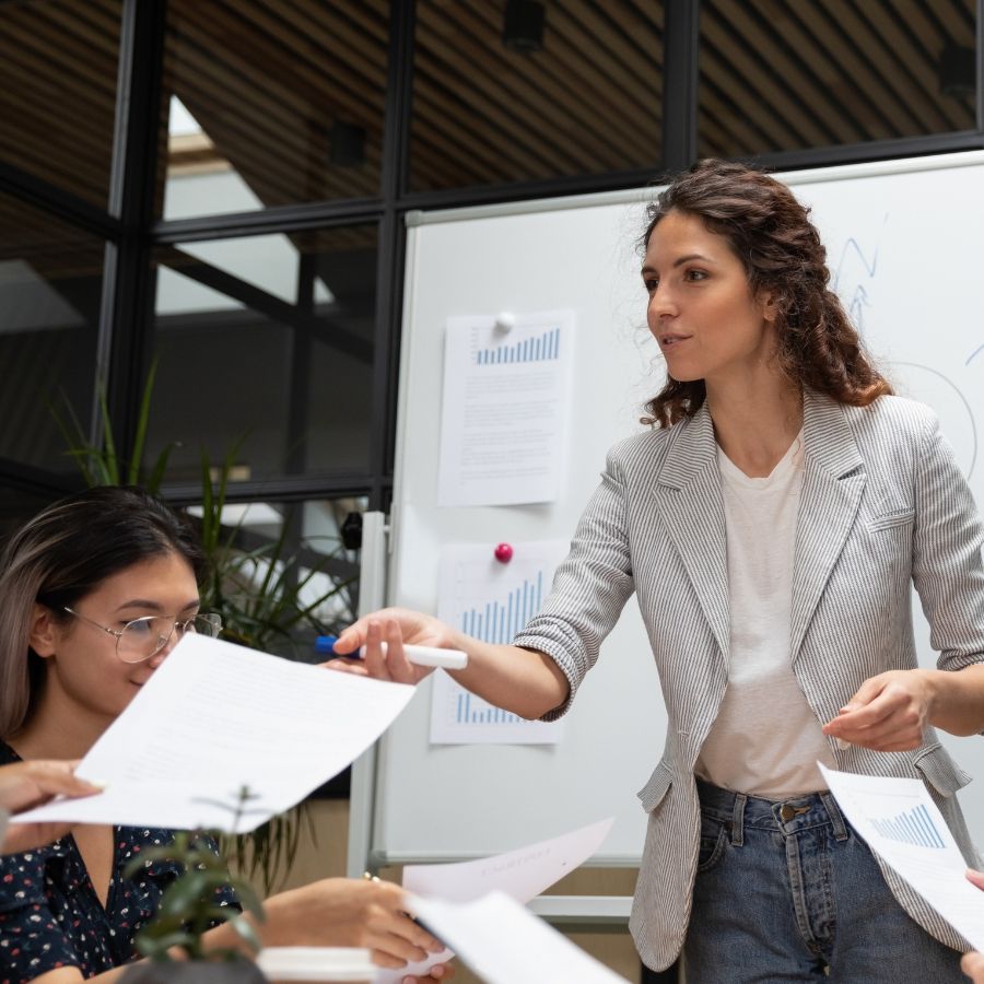 Businesswoman handing out printouts during a meeting