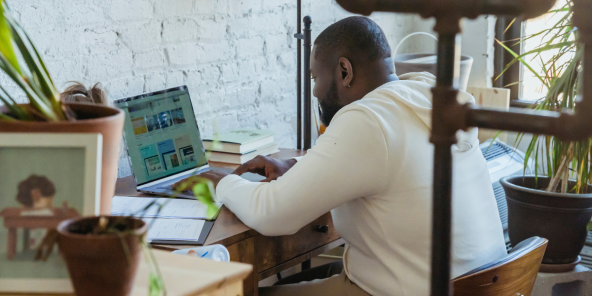 Black man typing on laptop