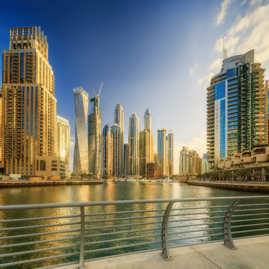 Panoramic view of Dubai Marina bay with yacht and cloudy sky, Dubai, UAE.