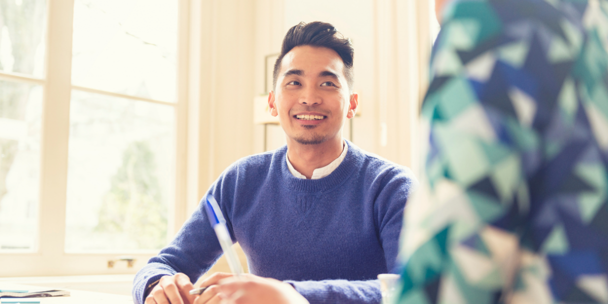 happy asian male professional in office