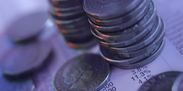 A pile of coins sitting on top of a financial document